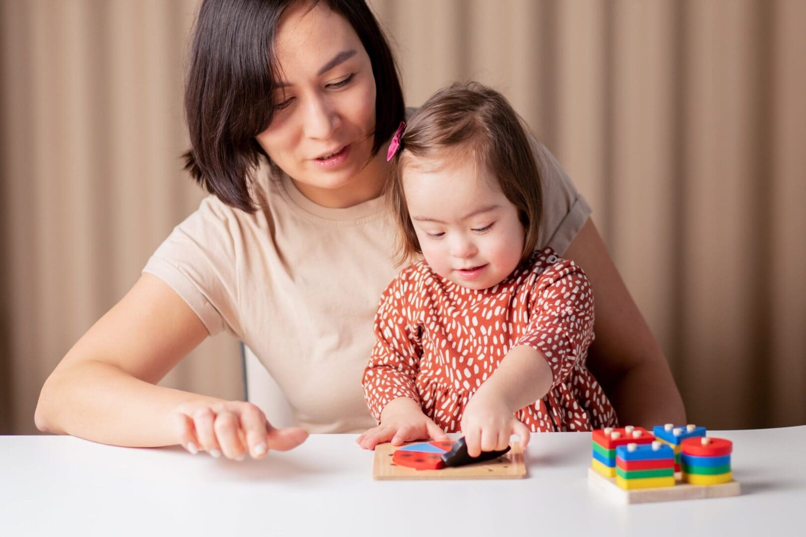 A woman and child playing with blocks on the table