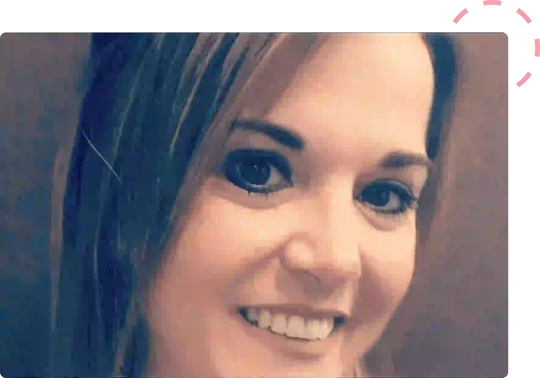 Close-up portrait of a smiling woman with light brown hair.
